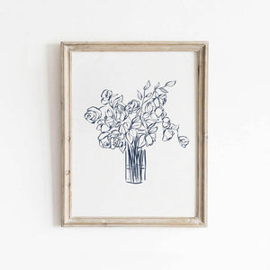 Navy blue floral line drawing wall art featuring roses and leaves in a tall vase, styled in a natural wood frame for bedroom or entryway decor.