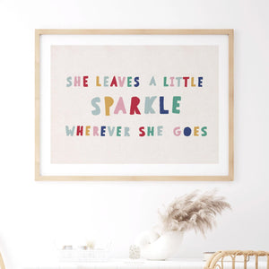 Framed rainbow quote print in light wood frame styled above a white console with pampas grass, perfect for girls rooms or playroom decor.