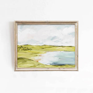 Landscape wall art print with green rolling hills and a reflective lake, styled in a neutral-toned room for nature-inspired decor.