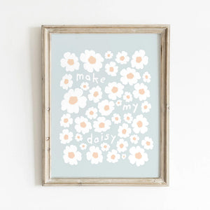 Framed daisy wall art with playful “make my daisy” text, styled in a cozy neutral-toned room with wicker accents—perfect for nursery, kids’ room, or cottagecore decor.
