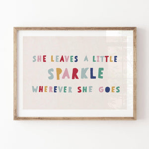 Close-up of colorful hand-lettered quote print in a rustic wood frame against a white wall, with soft shadows highlighting linen-style texture.