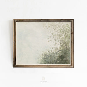 Vintage-style wall art print featuring a soft, misty sky and leafy green trees, styled in a warm wood frame against a white wall.