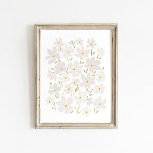 Framed white daisy wall art with soft florals, styled against a white wall for a light and airy look.