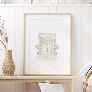 Vintage-inspired boulangerie art print framed and styled in a bright entryway with rustic accents and natural textures.