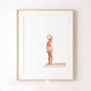 Coral swimsuit swimmer print in light wood frame, styled on a clean white wall to highlight soft coastal colours and minimalist artwork detail.