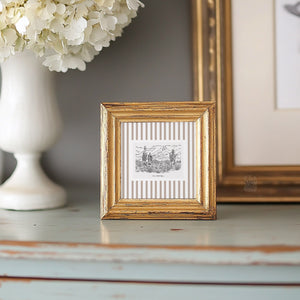 Framed Sonoran Desert sketch print styled on a vintage teal dresser with a gold frame and white hydrangeas, ideal for small accent spaces.