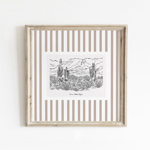 Neutral Sonoran Desert wall art with vertical taupe stripes, styled in a classic frame against a clean white wall for a modern coastal look.