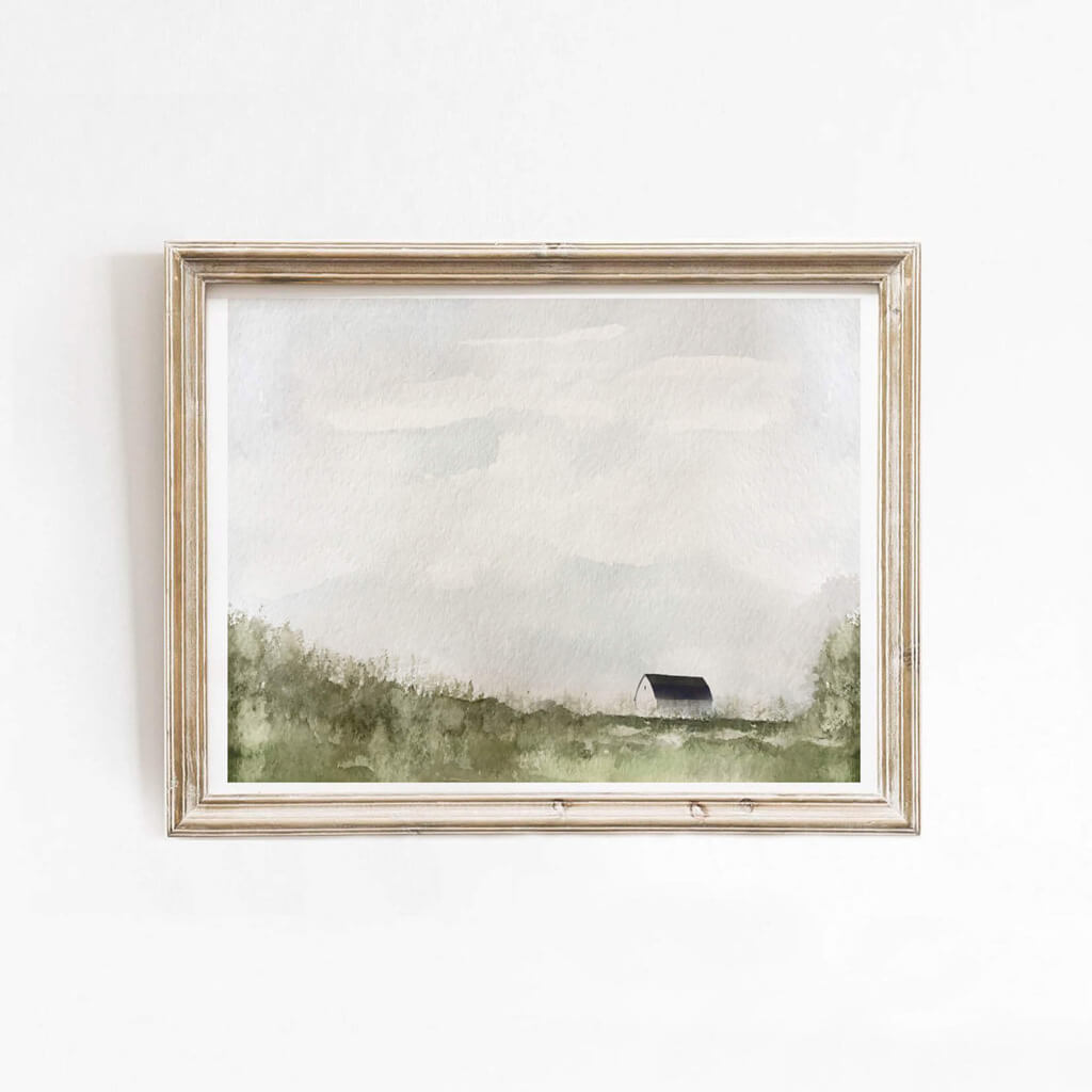 Barn Watercolor Print by artist Leah Straatsma; a small barn nestled among fields with a blue sky and clouds in the background.