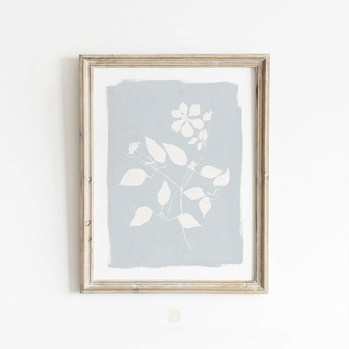 Minimalist floral wall art styled in a cozy neutral bedroom with woven textures and natural light