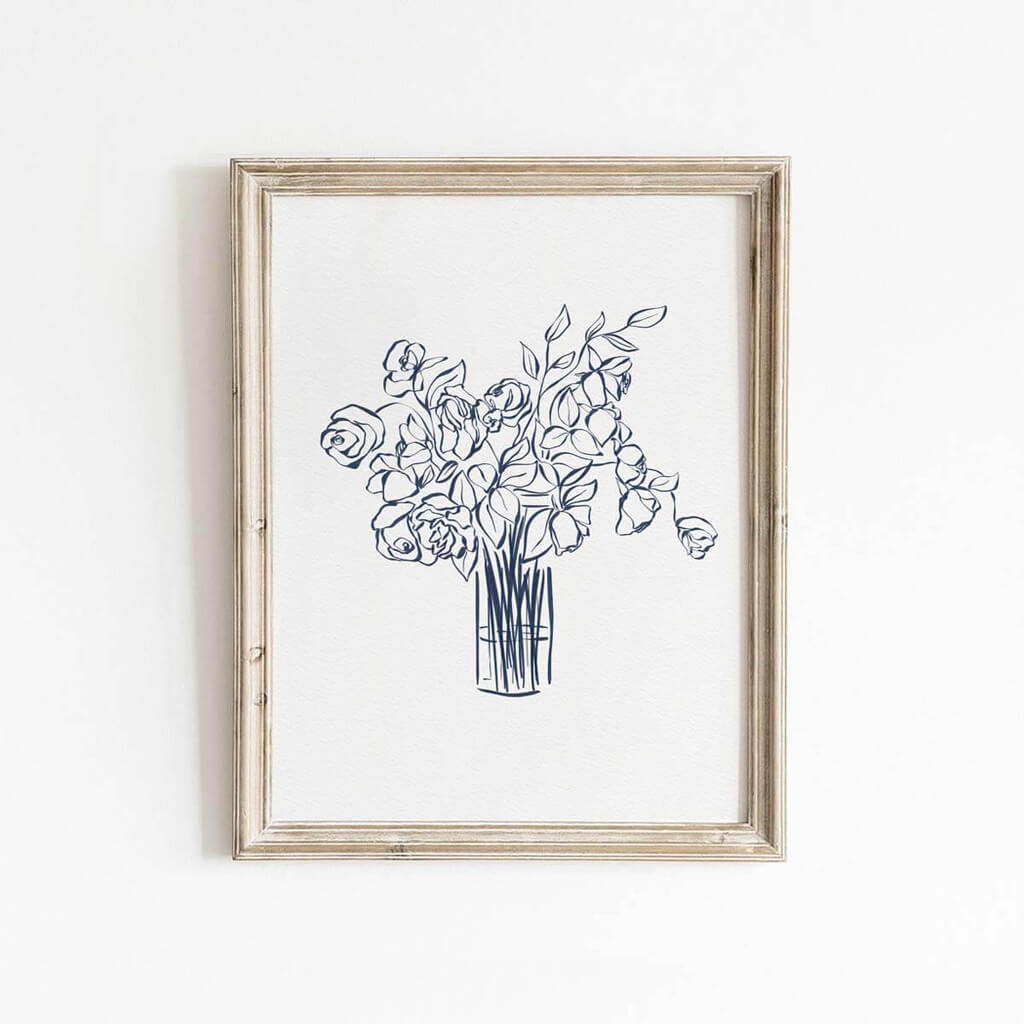 Navy blue floral line drawing wall art featuring roses and leaves in a tall vase, styled in a natural wood frame for bedroom or entryway decor.