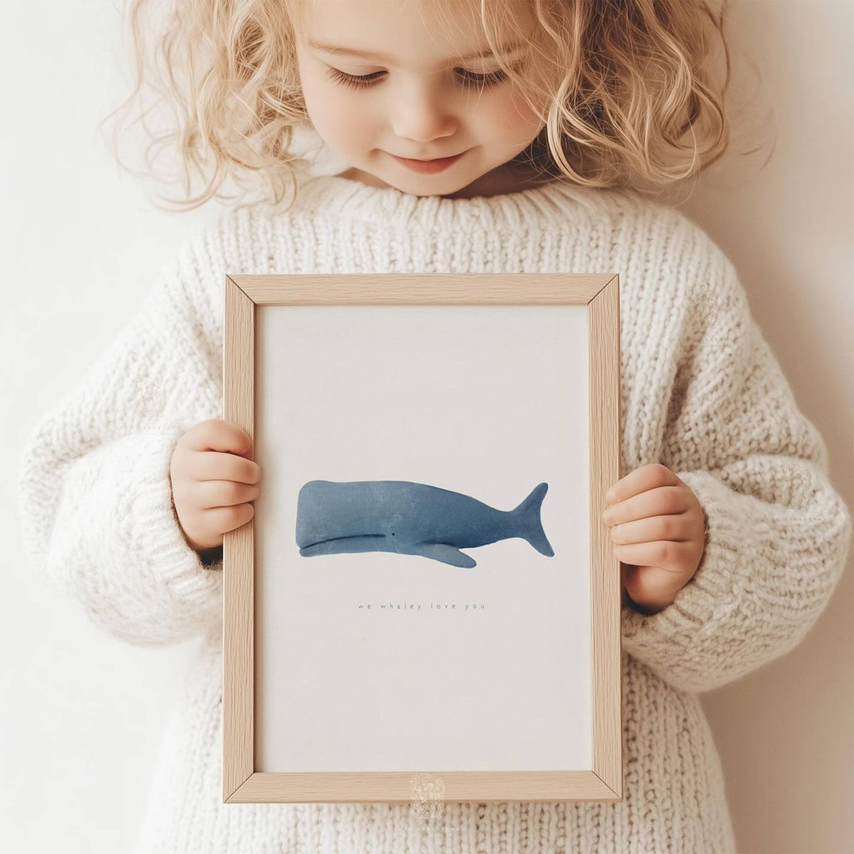 Minimalist blue whale print with the phrase &#39;we whaley love you,&#39; ideal for nursery or coastal decor.
