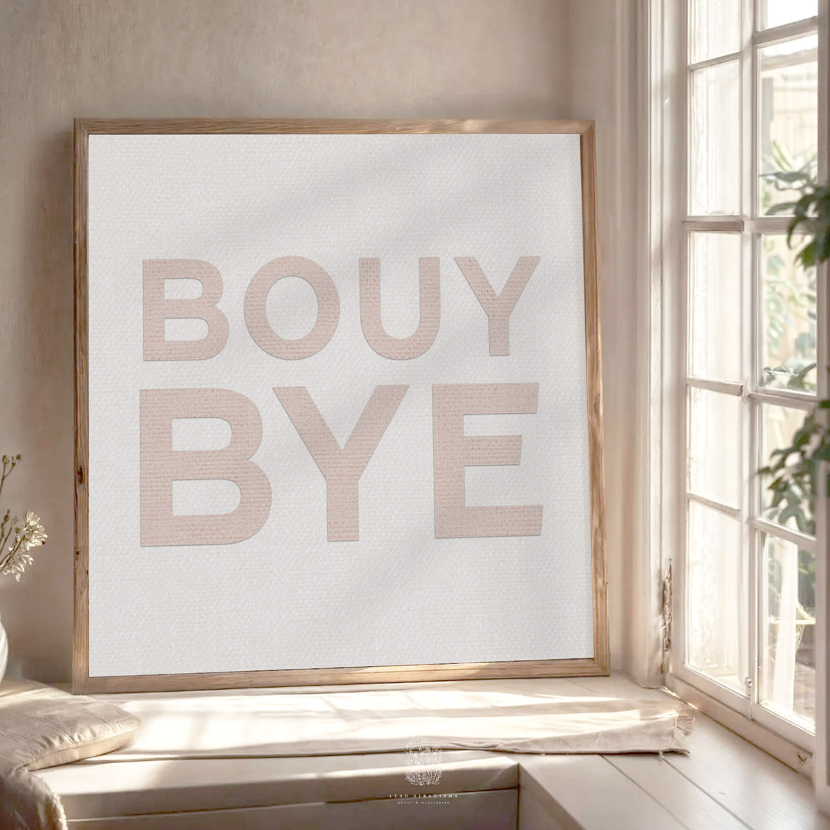 Blush pink “BOUY BYE” text art print in wood frame, styled by a window with soft natural light and warm neutral tones.