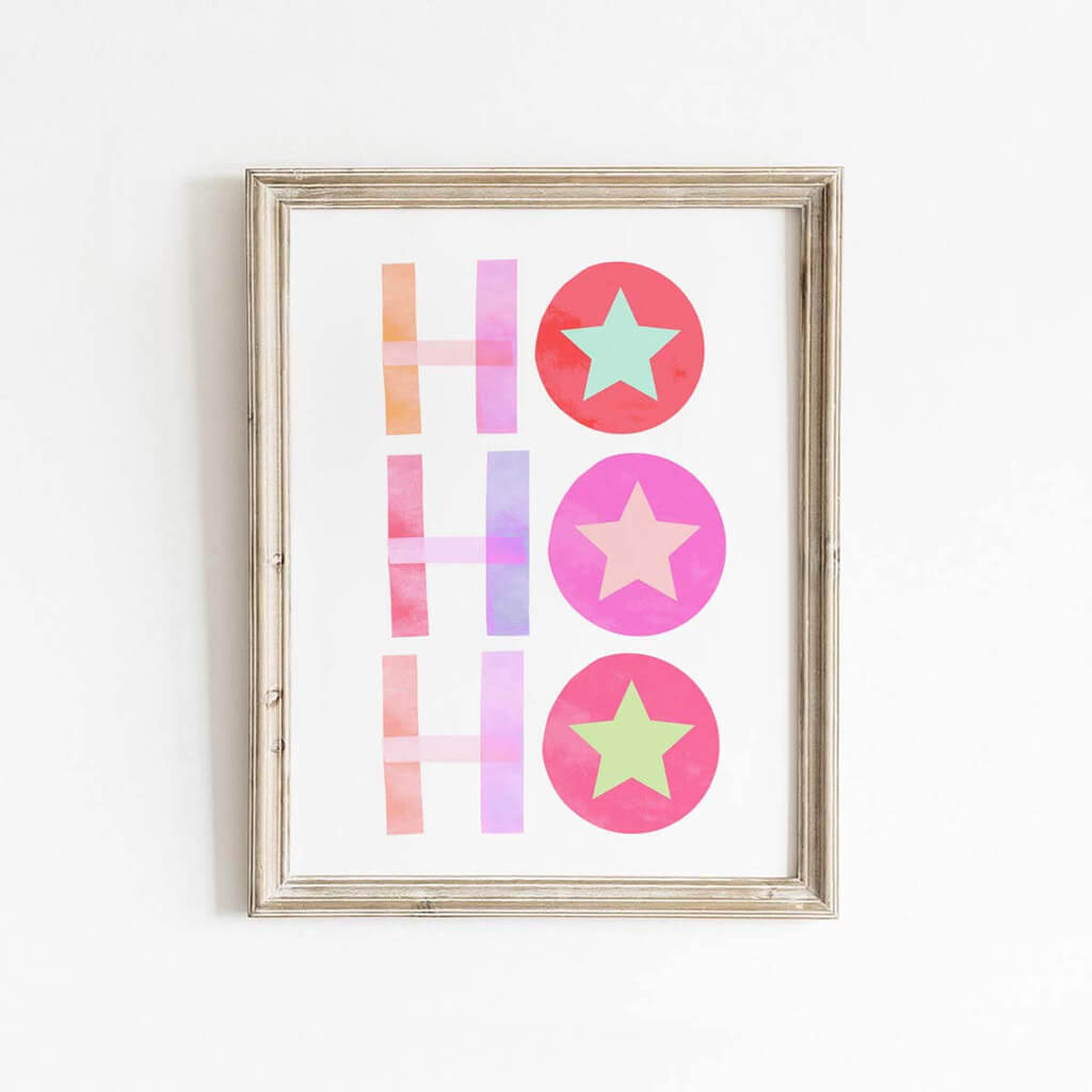 Framed Ho Ho Ho holiday print in bold pink, red, orange, and purple lettering with star accents, designed for playful Christmas decor in kids’ rooms or modern entryways.