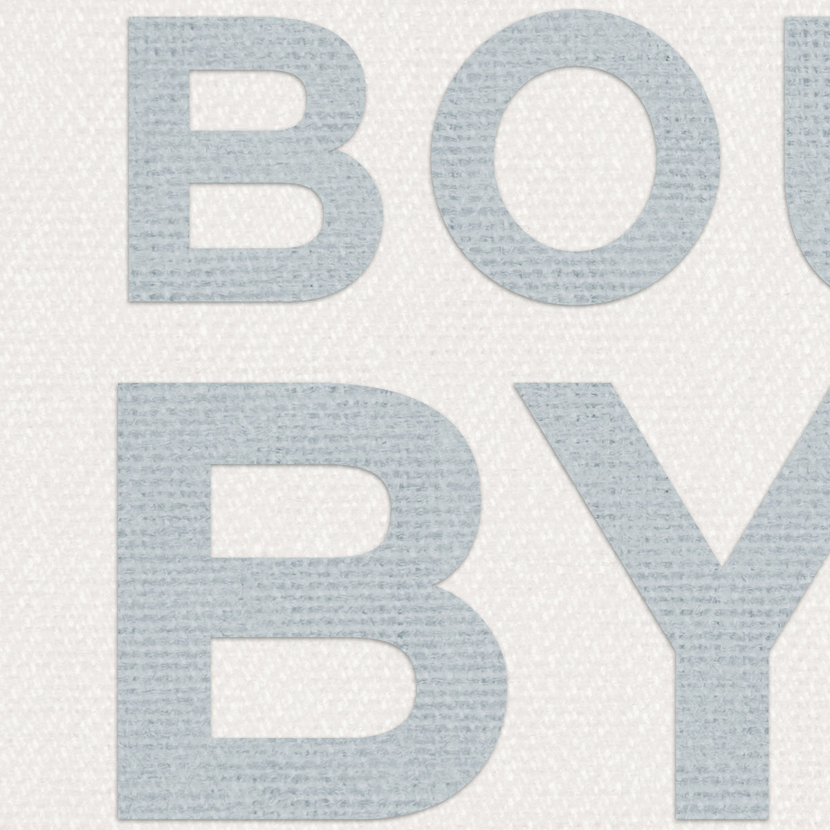 Close-up of blue “BOUY BYE” text on textured off-white fabric background, showing detailed woven texture of the coastal typography print.