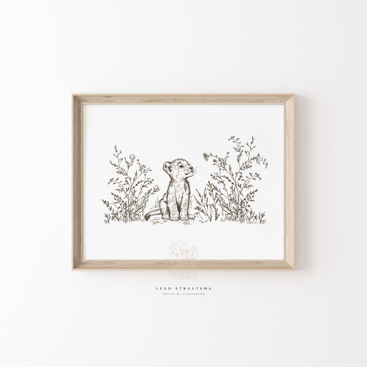 Framed lion cub wall art in soft sepia tones, styled above a nursery dresser for safari-inspired or gender-neutral baby room decor.