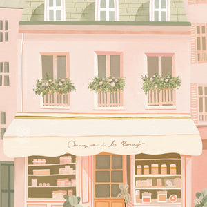 Close-up of a Parisian shop art print in pretty pastel pinks, green, and orange.