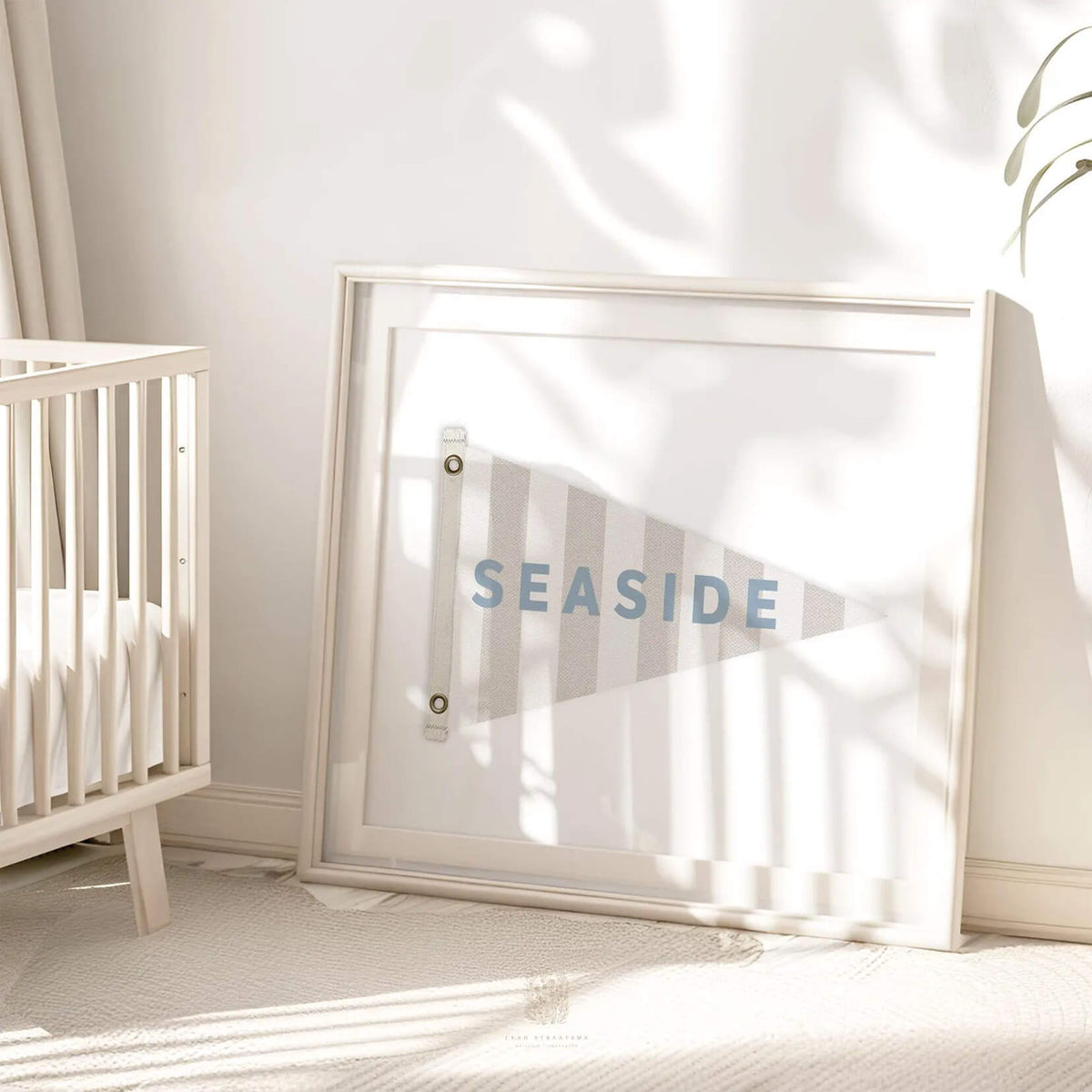 Seaside flag wall art print leaning against a nursery wall, styled with soft shadows and natural light. Perfect for coastal-inspired baby or kids&#39; room decor.