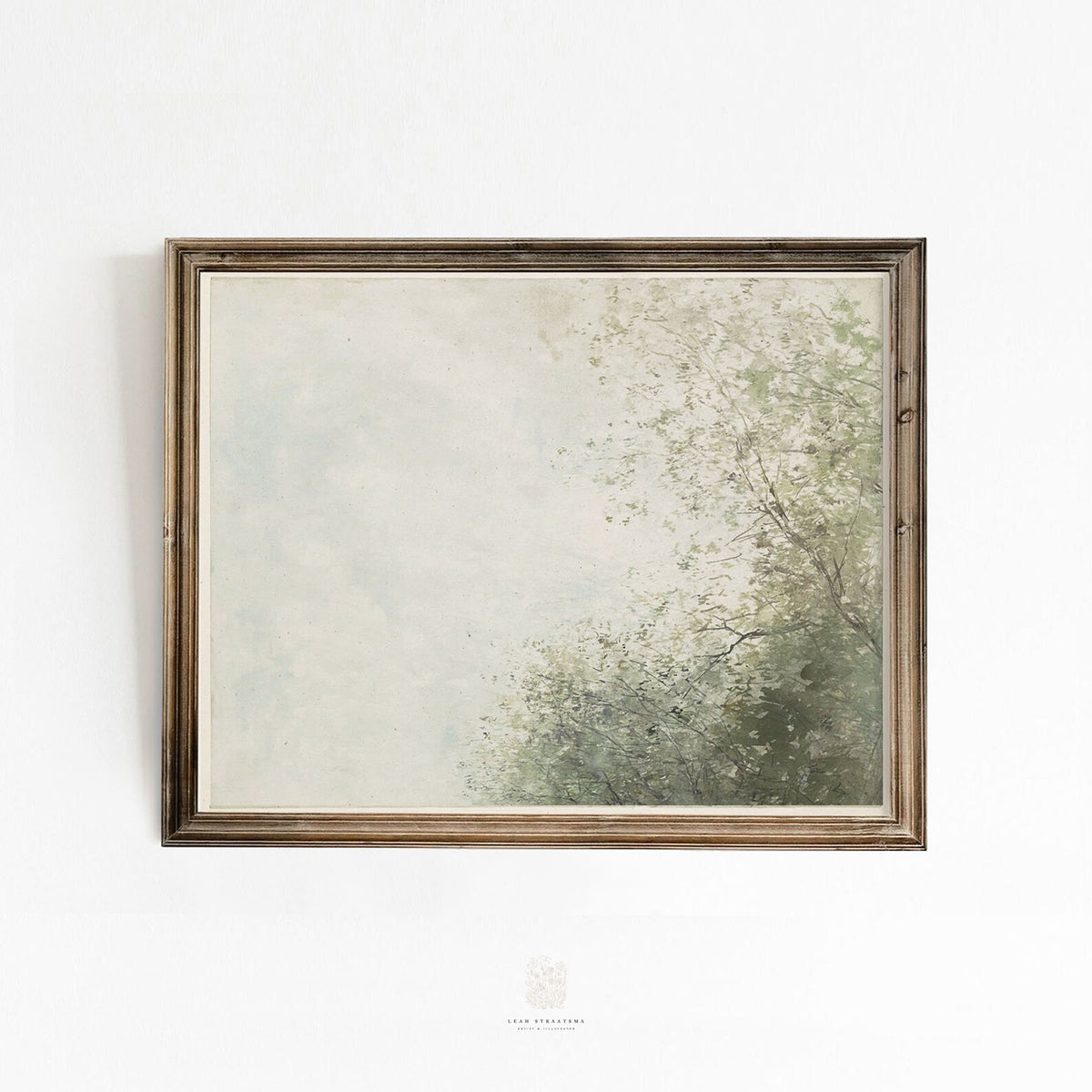 Vintage-style wall art print featuring a soft, misty sky and leafy green trees, styled in a warm wood frame against a white wall.