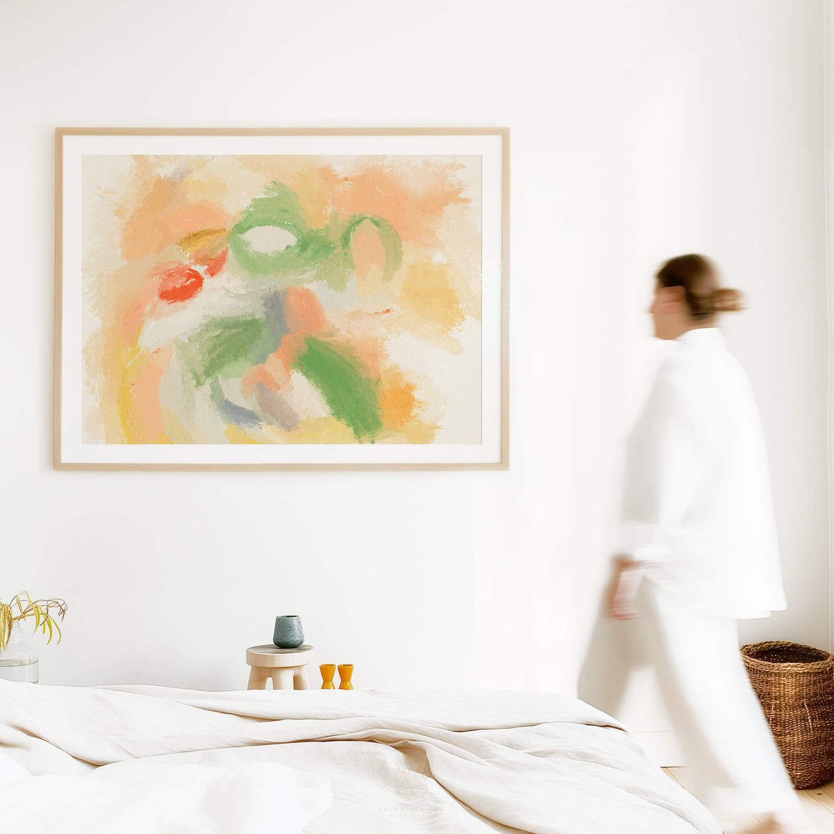 Framed abstract tulip artwork styled in a modern bedroom, featuring bold orange and green brushstrokes with soft pastel tones for a fresh, artistic feel.