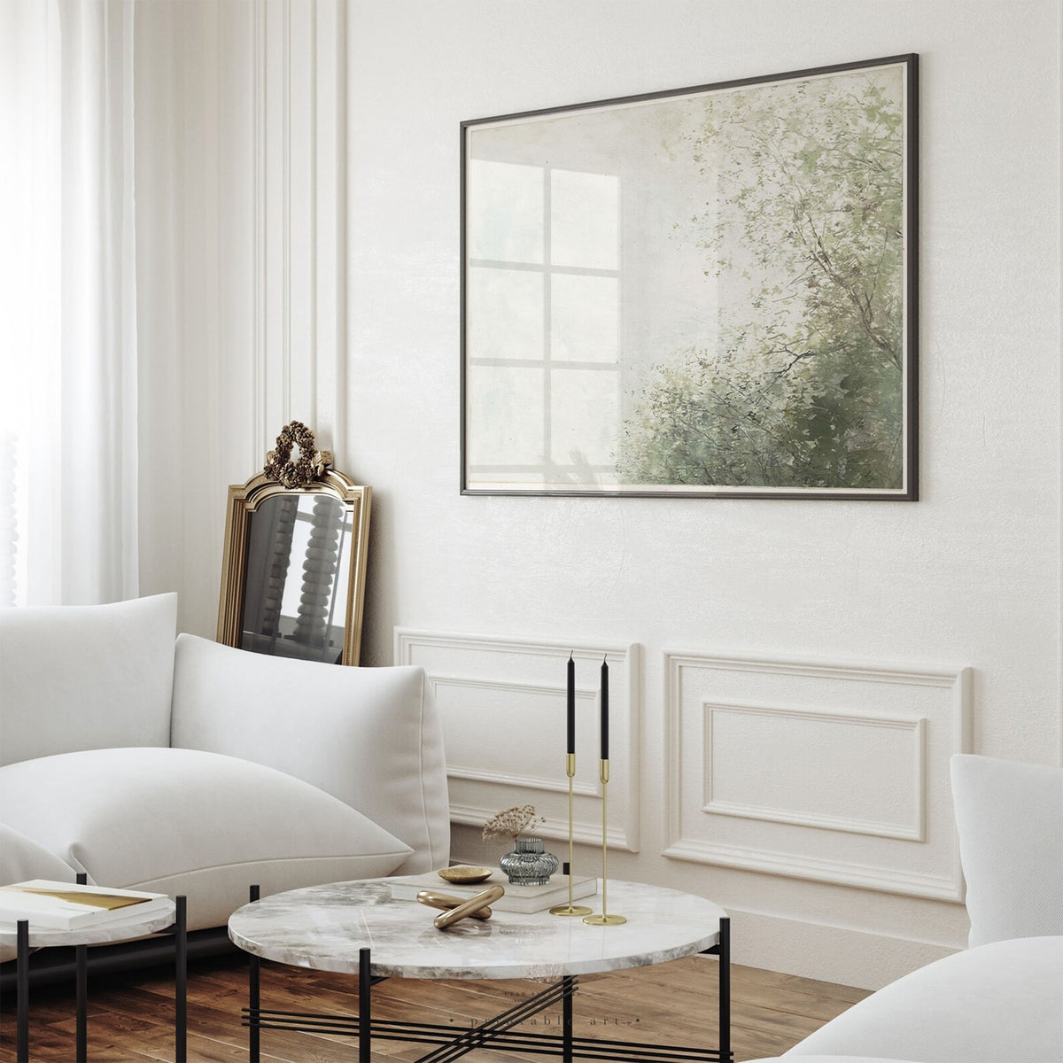 Serene tree and sky wall art styled above a white sofa in a classic, light-filled living room with soft neutral decor.