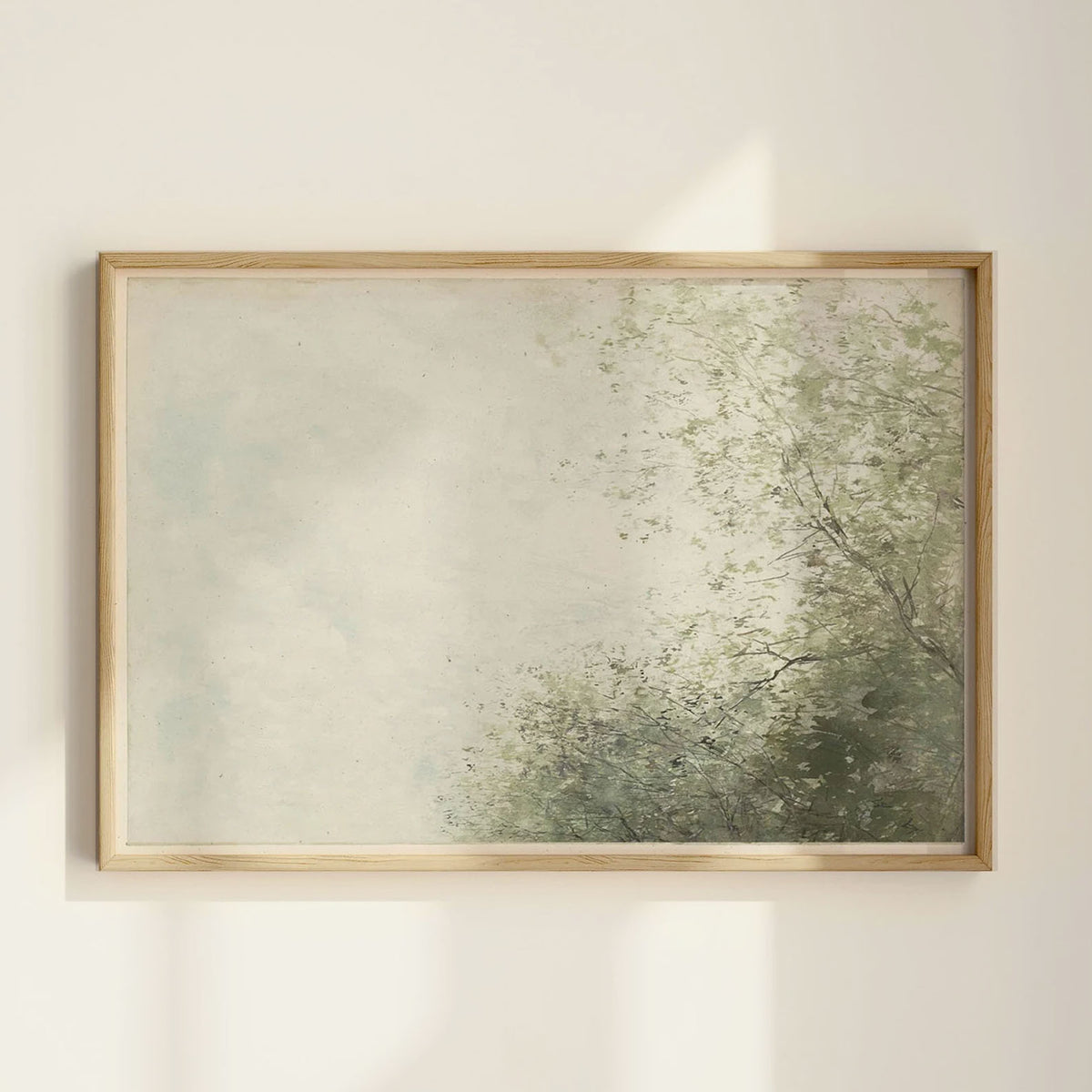 Vintage-style wall art print featuring a soft, misty sky and leafy green trees, styled in a warm wood frame against a warm creamy wall.