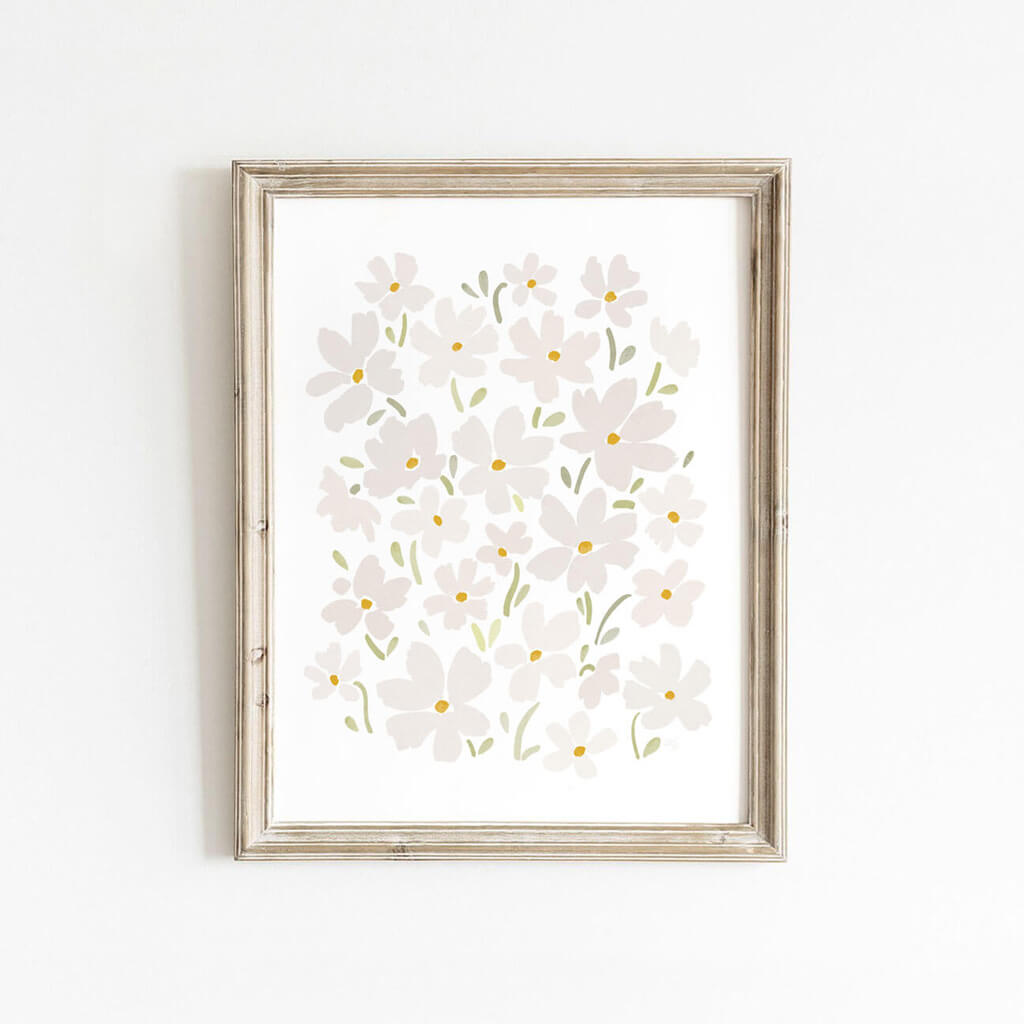 Framed white daisy wall art with soft florals, styled against a white wall for a light and airy look.