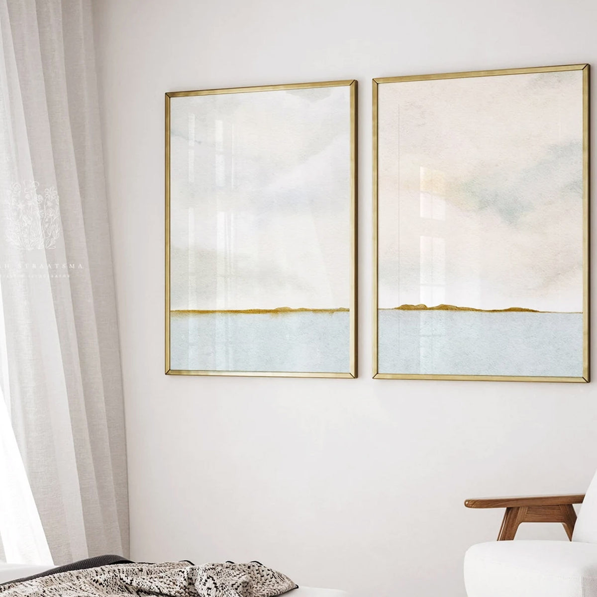 Pretty landscape watercolours featuring a calm lake, and billowy cloudy skies hung on a white wall in golf frames in a bedroom.