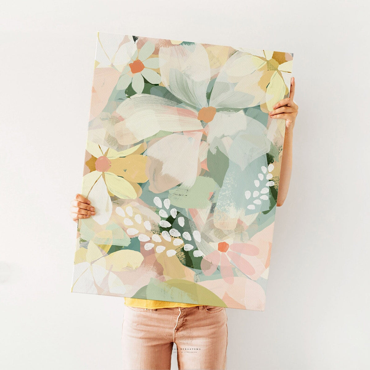 Large pastel daisy print held up against a white wall, showcasing bold brushstroke florals – perfect for modern flower-themed styling.
