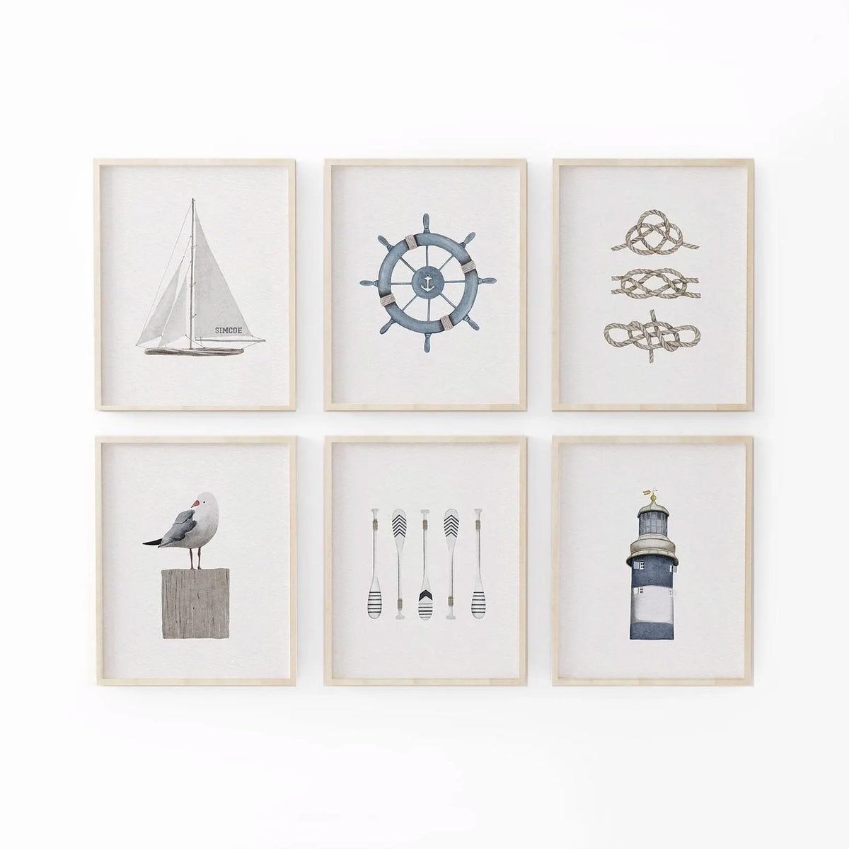 A gallery set of six framed nautical illustrations displayed together on a white wall, featuring a sailboat, ship’s wheel, decorative rope knots, seagull on a post, striped oars, and a lighthouse. The neutral beige and blue tones create a coastal-inspired wall art collection, perfect for beach house decor or nautical gallery walls.