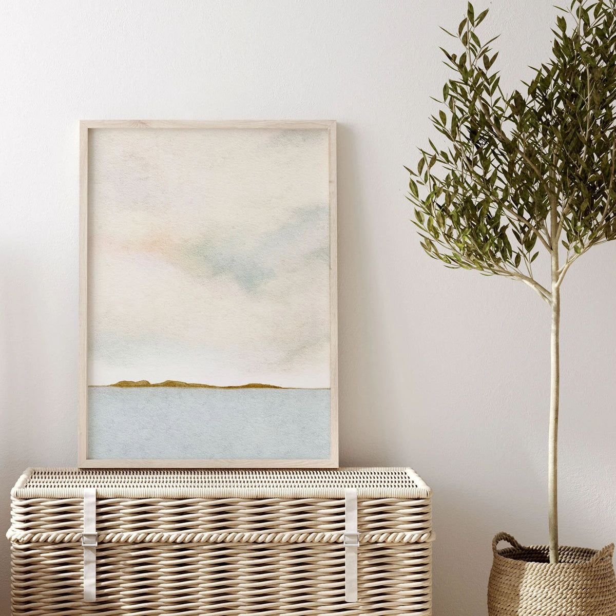 Minimalist coastal landscape wall art with soft blue waters, a warm neutral sky, and a golden shoreline, perfect for home office or entryway decor.